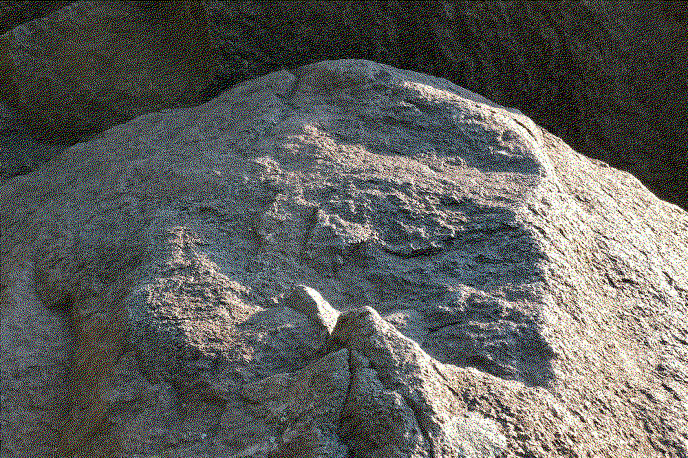 a photograph of a rough rock, half shaded